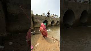 A woman catches fish from a large dam with a hook  amazing fishing in the canal  fishing shorts [upl. by Bealle617]