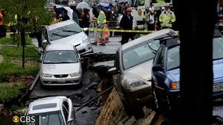 Street collapse in Baltimore sends parked cars tumbling [upl. by Tierney]