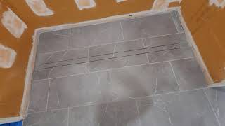 Curbless linear drain shower floor is tiled [upl. by Arrek259]