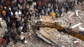 Egyptians sift through rubble of collapsed building [upl. by Yatnoed]