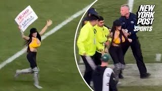 Woman runs onto field waving proTrump sign during JetsSteelers game [upl. by Euseibbob]