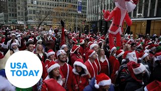 Thousands of Santas and Grinches gather in Times Square for Santacon  USA TODAY [upl. by Gove]