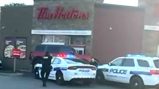 Wild getaway attempt at Tim Hortons drivethru  Suspect drives over police cruiser [upl. by Aicertap]