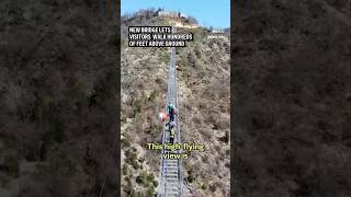 New ‘Tibetan’style bridge lets thrillseekers walk over 500 feet above the ground [upl. by Deyes]