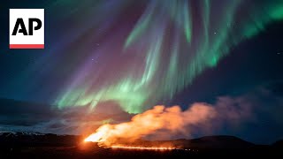 Northern Lights shine over Icelands erupting volcano [upl. by Nylatsyrk]