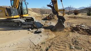 CAT 310 Excavator Breaking up a Concrete Pad [upl. by Champaigne]