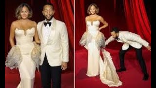 Doting husband John Legend fixes wife Chrissy Teigens dress on the red carpet as the pair attend [upl. by Ruyle597]