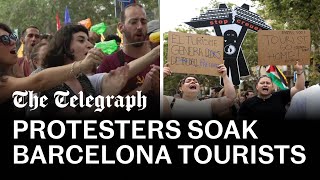 Antitourism protesters soak diners with water pistols in Barcelona [upl. by Casavant]