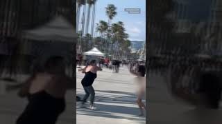 Naked woman swings spiked bat on Venice Beach [upl. by Jerol580]