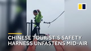 Safety cord tied to Chinese tourist unfastens midjump on highaltitude bridge [upl. by Farrish]