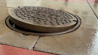 Manhole cover bounces and flaps as storm deluges Mobile [upl. by Yelbmik]