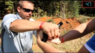 How To Disarm A Handgun Held With Both Hands  Tactical Minute [upl. by Aiclef175]