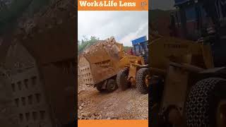 A bulldozer uses a sidetilt bucket to dump rocks efficiently without facing the truck directly [upl. by Eiramanin583]