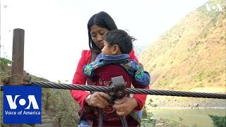 Villagers in southwest China hang on for dear life to cross rivers on ziplines [upl. by Quickman]