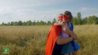 Loving dad embracing cute daughter in superhero costume in summer nature [upl. by Edya366]