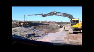 Volvo EC 235C Spreading bentonite mats with a long reach lifting boom [upl. by Oinegue]