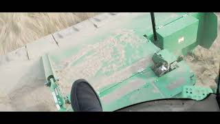 Running a John Deere W260R with 16 foot disc header cutting lovegrass [upl. by Lyrad]