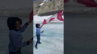 Athabasca glacier and Canadian flag off Columbia icefields Jasper [upl. by Oram]