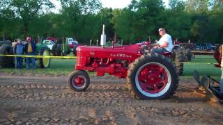 Farmall pulling power Various Farmall tractors pulling a sled at a antique tractor pull [upl. by Radmen977]