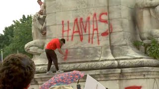 Protester sprays Hamas is comin on Christopher Columbus statue in Washington DC [upl. by Nico]