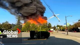 Massive fire in Vancouver brings down crane destroys home [upl. by Suirtemid]