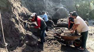 Manual sand miners break and clean the large rocks that cover the black sand they are truly mighty [upl. by Saduj]