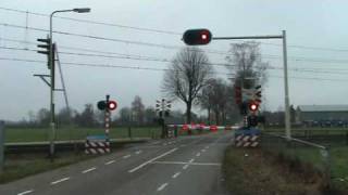 Dutch railroad crossing at Sevenumthe NetherlandsDecember 32008 and intercity train passing [upl. by Llerrehc544]