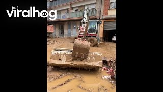 Excavator Operator Uses Refrigerator As Broom During Cleanup Efforts  ViralHog [upl. by Eillor]